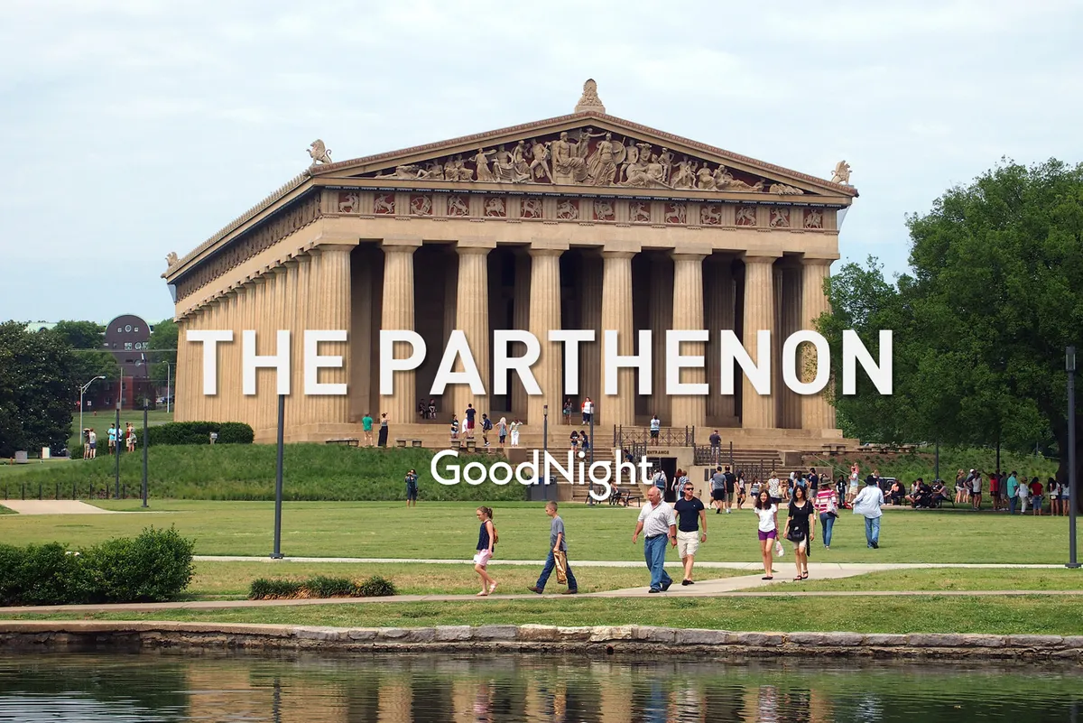 An expansive view of Centennial Park featuring the Parthenon replica, with visitors strolling on lush green grass and walking by reflective water. The atmosphere is relaxed and community-oriented—ideal for picnics, playtime, and outdoor relaxation.