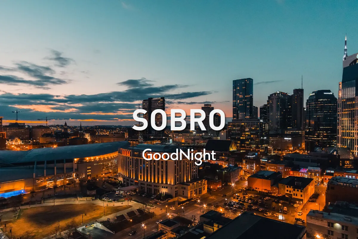 A twilight view of the Nashville skyline featuring city lights glowing against the dusky sky, with bustling streets and hints of nightlife coming to life below.