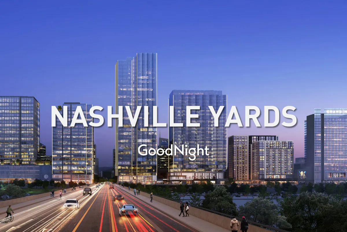 A dynamic exterior city view featuring Nashville skyscrapers, illuminated streets, and the energetic pulse of the downtown area at night—suggesting proximity to business hubs, nightlife, and cultural venues.